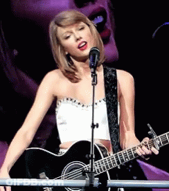 Woman Singing Into Microphone And Guitar GIF