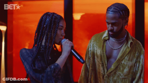 Woman Singing Into Microphone And Man With BET Logo GIF
