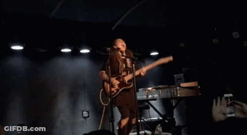 Woman Singing Into Microphone And Playing Guitar GIF