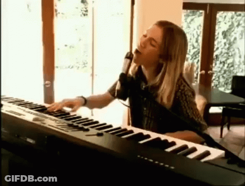 Woman Singing Into Microphone And Playing Keyboard GIF