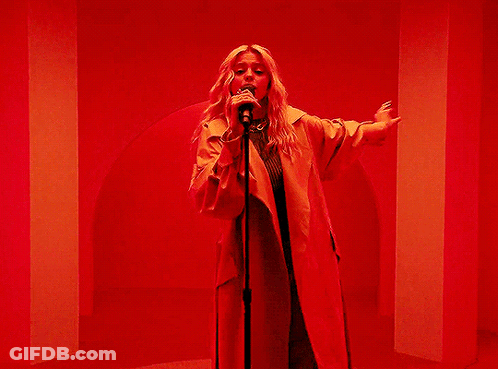 Woman Singing Into Microphone Arms Outstretched GIF