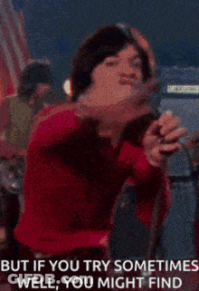 Woman Singing Into Microphone But If You Try Sometimes Well You Might Find GIF