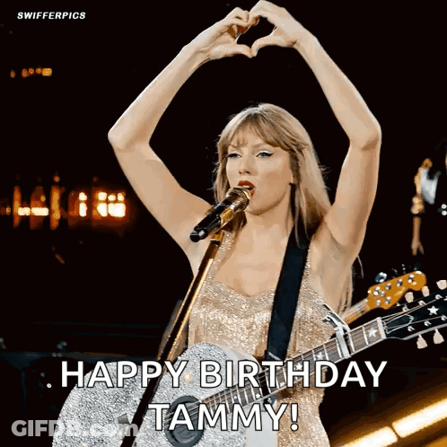 Woman Singing Into Microphone Holding Guitar Making Heart With Hands GIF