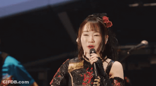 Woman Singing Into Microphone In Black Dress GIF
