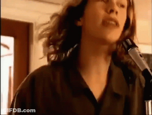 Woman Singing Into Microphone In Dark Room GIF