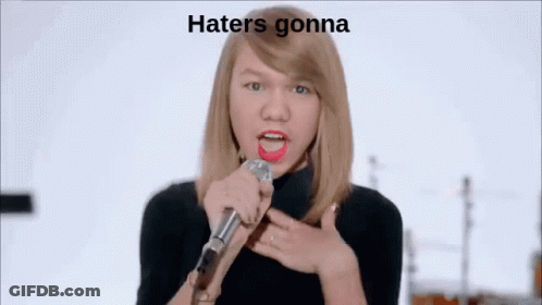 Woman Singing Into Microphone In Front Of Band Saying Hate GIF
