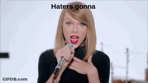 Woman Singing Into Microphone In Front Of Band Saying Hate GIF
