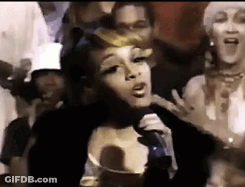 Woman Singing Into Microphone In Front Of Crowd GIF