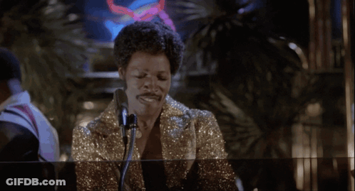 Woman Singing Into Microphone In Front Of Glass Wall GIF