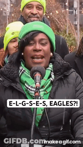 Woman Singing Into Microphone In Green Hat And Scarf GIF