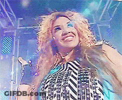 Woman Singing Into Microphone In Striped Shirt GIF