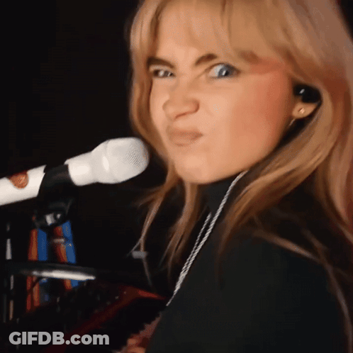 Woman Singing Into Microphone Making Face GIF