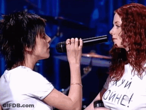 Woman Singing Into Microphone Next To Woman In Oihae T-Shirt GIF