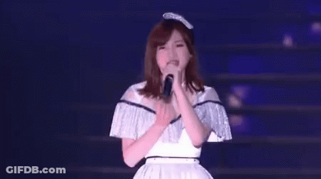 Woman Singing Into Microphone On Stage GIF