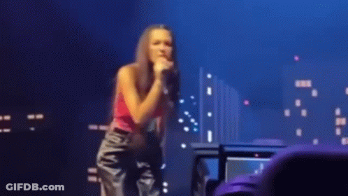 Woman Singing Into Microphone On Stage GIF