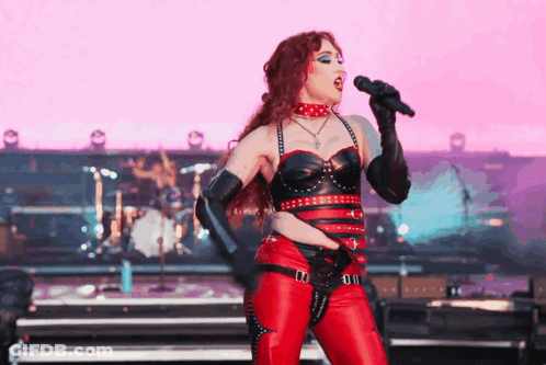 Woman Singing Into Microphone On Stage GIF