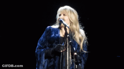 Woman Singing Into Microphone On Stage GIF