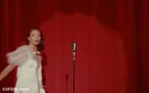 Woman Singing Into Microphone On Stage GIF