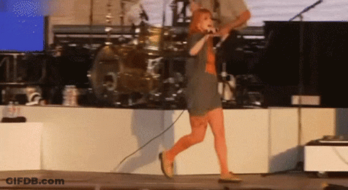 Woman Singing Into Microphone On Stage GIF