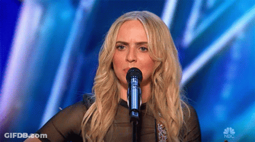Woman Singing Into Microphone On Stage GIF