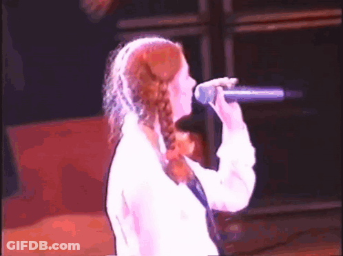 Woman Singing Into Microphone On Stage GIF
