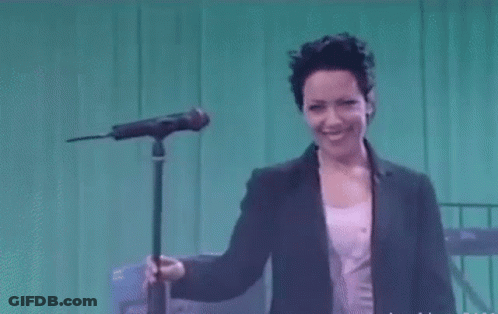 Woman Singing Into Microphone Smiling GIF