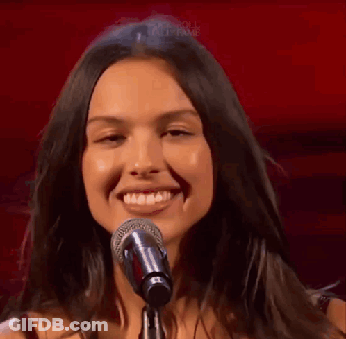 Woman Singing Into Microphone Smiling GIF