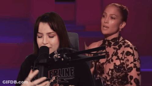 Woman Singing Into Microphone Wearing Epine Shirt GIF