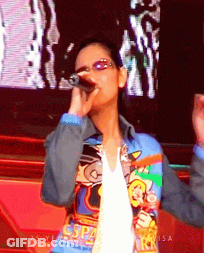 Woman Singing Into Microphone Wearing ESP4 Jacket GIF