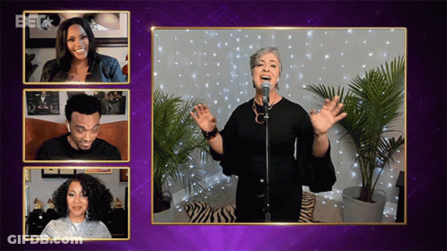 Woman Singing Into Microphone While Man And Woman Look On GIF