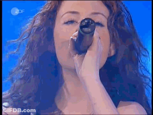 Woman Singing Into Microphone With 2DF Logo GIF