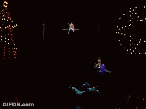 Woman Singing Into Microphone With Christmas Tree GIF