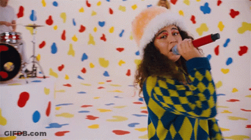 Woman Singing Into Microphone With Confetti GIF