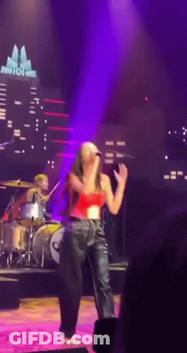 Woman Singing Into Microphone With Drummer GIF