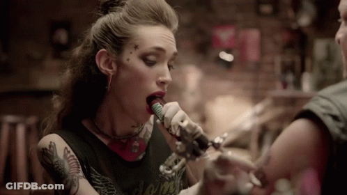 Woman Singing Into Microphone With Forehead Tattoo GIF