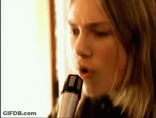 Woman Singing Into Microphone With Headphones GIF