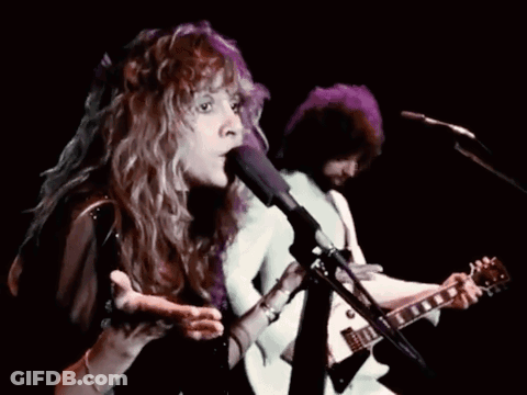 Woman Singing Into Microphone With Man Playing Guitar GIF