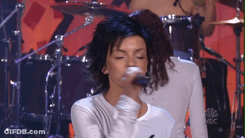 Woman Singing Into Microphone With NBC Logo GIF
