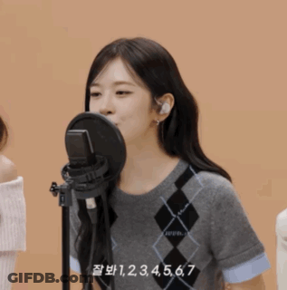 Woman Singing Into Microphone With Numbers 1 Through 7 GIF
