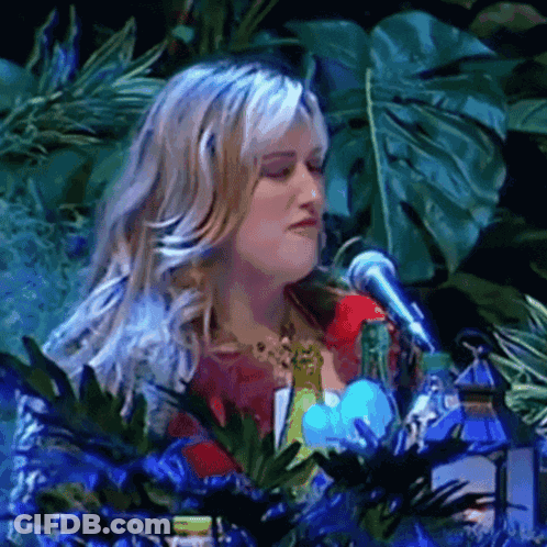 Woman Singing Into Microphone With Plants GIF