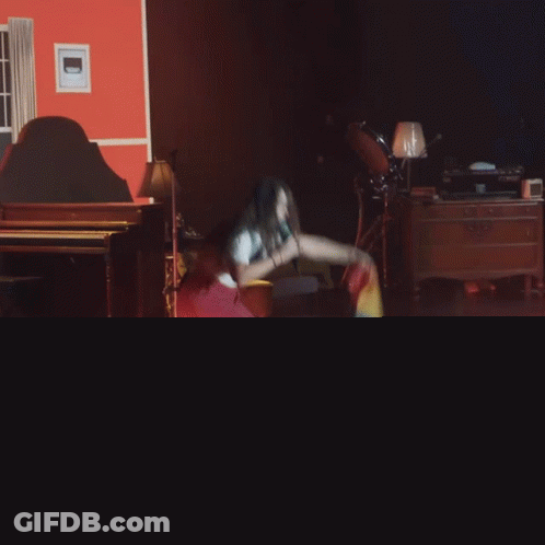 Woman Singing Into Microphone With Rainbow Flag GIF