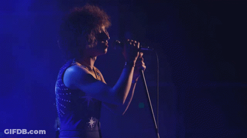 Woman Singing Into Microphone With Star GIF
