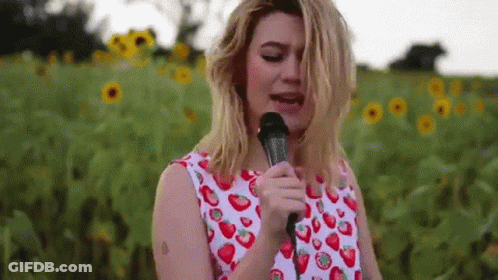 Woman Singing Into Microphone With Strawberries GIF