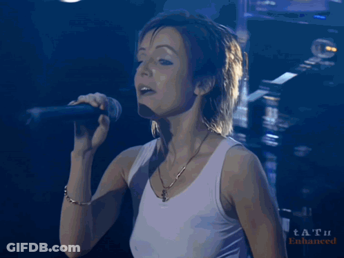 Woman Singing Into Microphone With Tat Watermark GIF