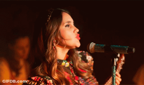 Woman Singing Into Microphone With Tongue Out GIF