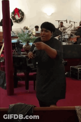 Woman Singing Into Microphone With Wreath GIF