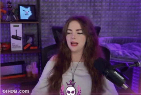 Woman Singing Into Shure Microphone With Headphones And Skull Necklace GIF