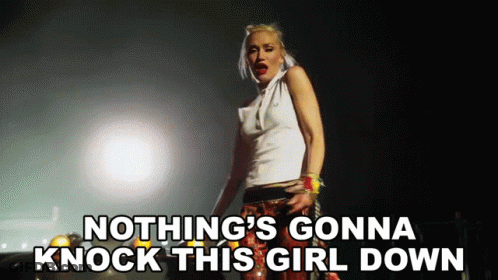 Woman Singing Nothing's Gonna Knock This Girl Down In Dark Room GIF