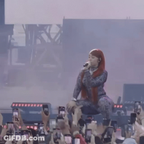 Woman Singing On Stage Crowd Taking Pictures With Phones GIF