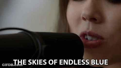 Woman Singing Skies Of Endless Blue Into Microphone GIF
